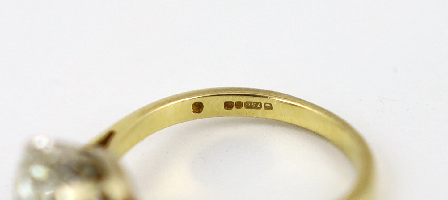 A modern 18ct gold and solitaire diamond set ring